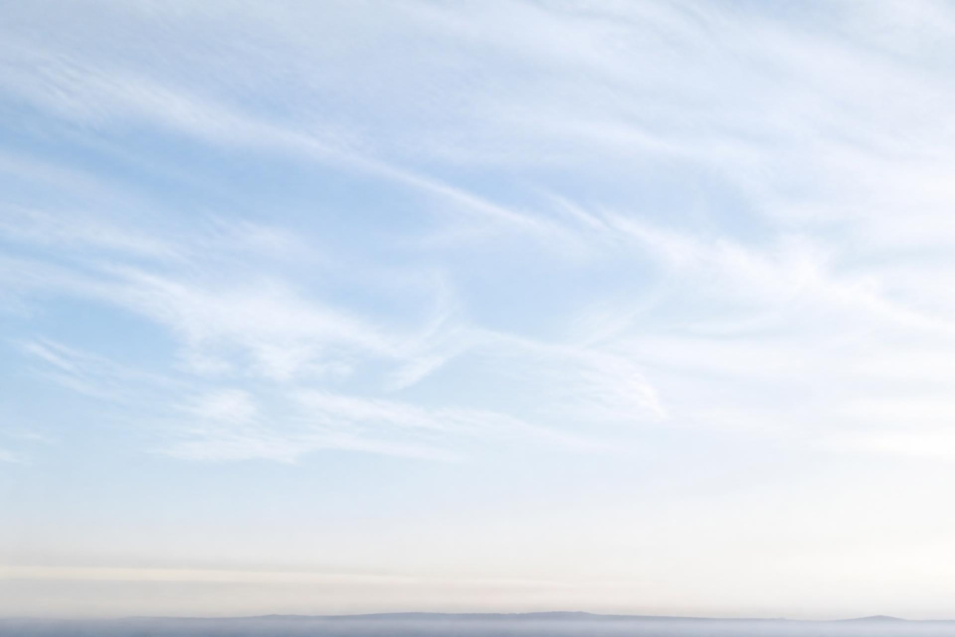 Pale open sky with thin high cloud, graded cool blue